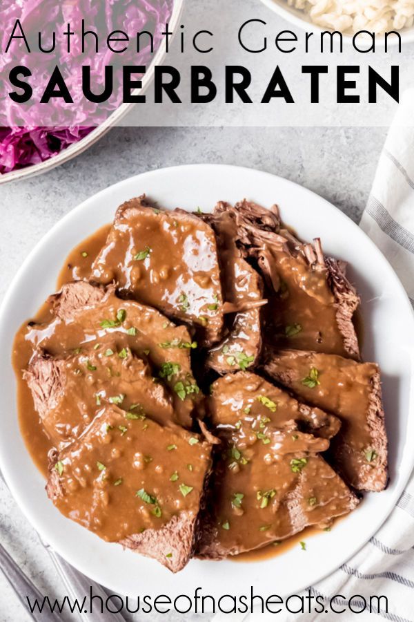 a white plate topped with meat covered in gravy