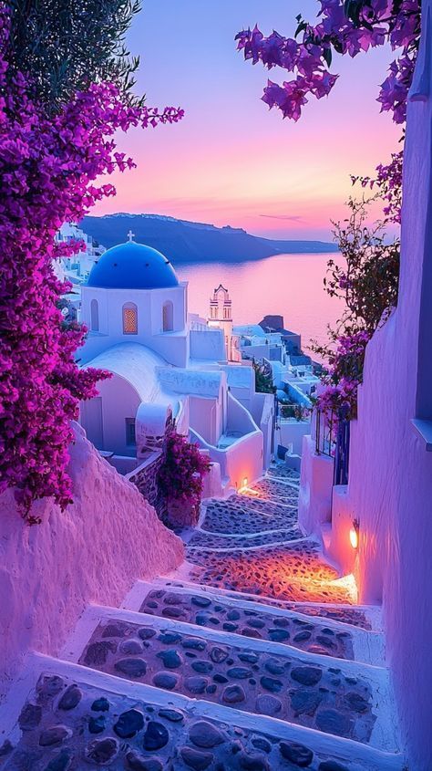 an alley way with steps leading to the water and buildings in the background at sunset