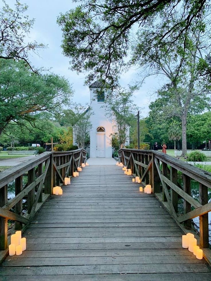 a wooden bridge with lit candles on it