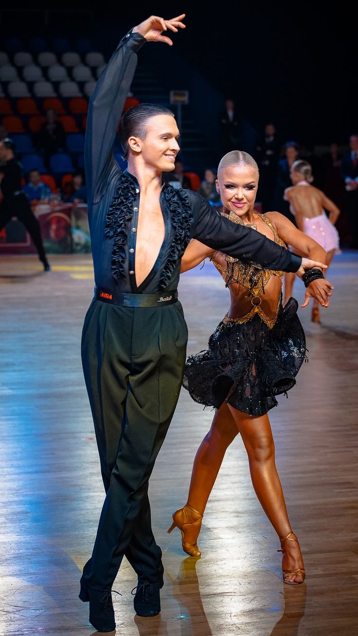 two people are dancing on the dance floor