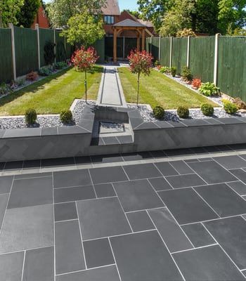 an outdoor garden with stone walkways and landscaping