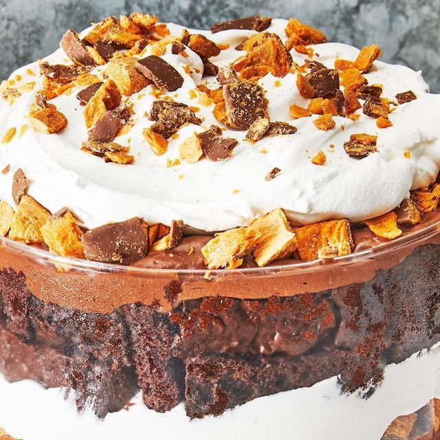 a chocolate cake topped with whipped cream and nuts