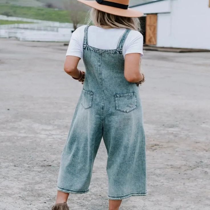 Cropped Denim Overalls This oversized silhouette is the perfect slouchy relaxed fit. Its washed denim is a loose fit with adjustable button straps and some distressed detailing. Oversized relaxed fit – if you are between sizes, please size down. Approximate measurements are as follows | SMALL | Bust: 40" (measured from under arm), Waist: 50, Length: 35" (from under the arm to hem), Inseam: 21" MEDIUM | Bust: 42" (measured from under arm), Waist: 52, Length: 35 1/4" (from under the arm to hem), I Ruffled Denim Jacket, Cute Overalls, Three Bird Nest, Nashville Outfits, Black Overalls, Baggy Style, High Hopes, Rainy Day Outfit, Overalls Women