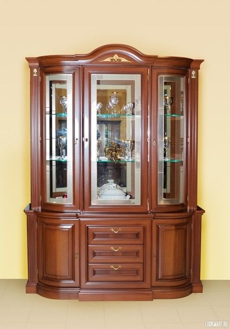 a wooden china cabinet with glass doors and drawers