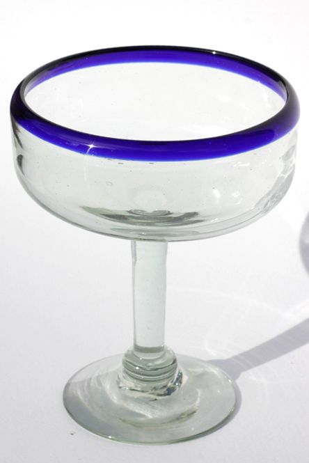 a blue rimmed glass bowl on a white surface