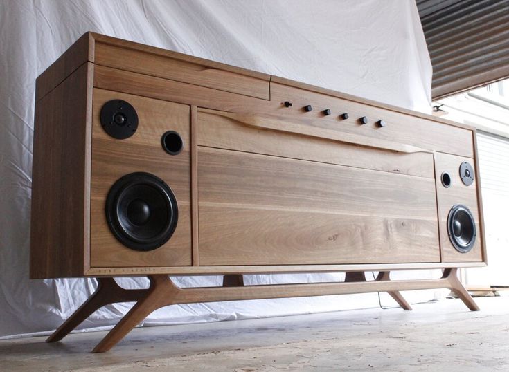 a wooden cabinet with speakers on it