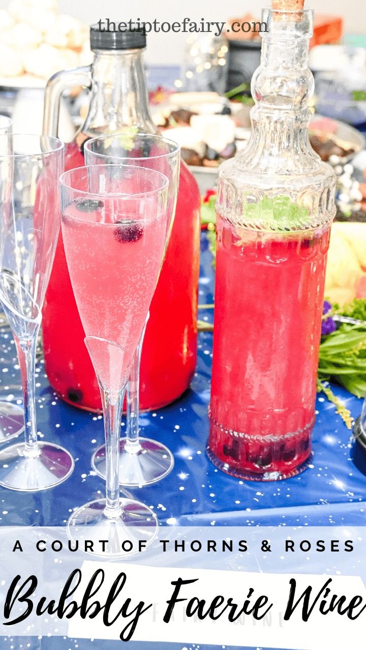 there is a bottle of wine and two glasses with liquid in them on the table