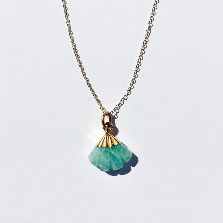 This genuine Amazonite Necklace Pendant, also known as Amazon Stone hangs on a sterling silver plated 18K Gold chain. The teal green gemstone necklace is handcrafted with a delicate and feminine style. Amazonite stone comes from Brazil and ranges in color from blue to green and can often be found with white, yellow, or gray inclusions to its blue sheen. There are various claims about the mystical properties of amazonite. It's also widely believed that amazonite stones have powerful curative prop Handmade Elegant Amazonite Necklace, Elegant Amazonite Jewelry Gift, Elegant Amazonite Jewelry For Gifts, Amazonite Gemstone Necklaces For Jewelry Making, Dainty Jade Gemstone Jewelry, Elegant Amazonite Necklace For Gift, Elegant Gold Amazonite Necklace, Gemstone Flower Pendant Necklace For Healing, Handmade Amazonite Pendant Necklace