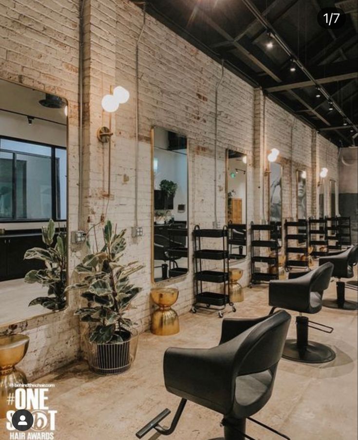 the interior of a hair salon with chairs and mirrors