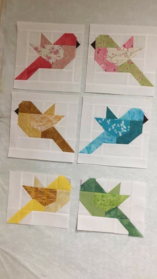 four pieces of paper with different colors and shapes on them, one has an arrow in the middle