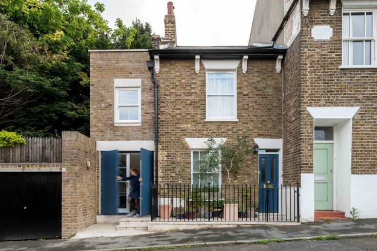 a brick house with blue doors and windows