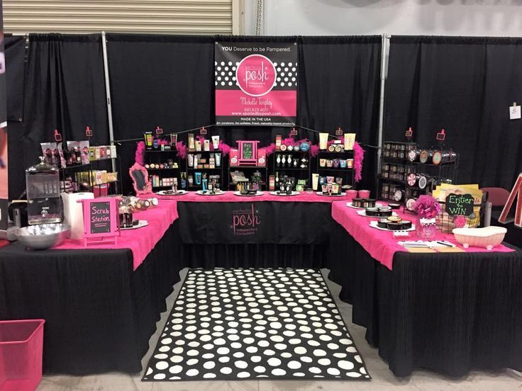 a booth set up with pink and black accessories on the tables, polka dot tablecloths