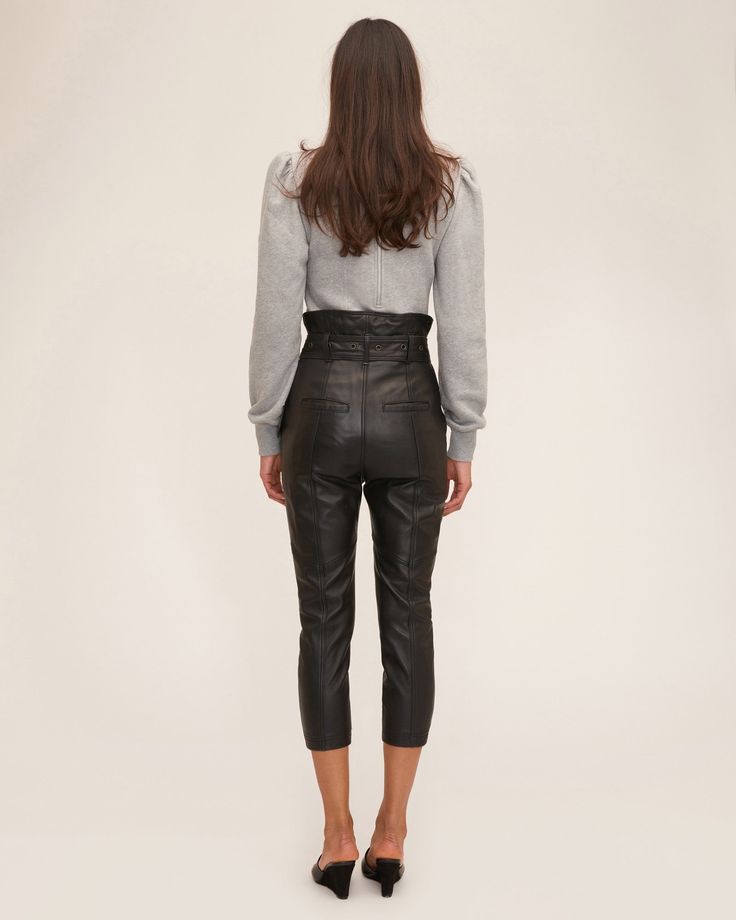 An update to our high-waist leather pant, the Anniston features a removable D-ring grommet belt and slightly tailored fit. High-waist fit Asymmetrical waist detail Slim fit Functional front slant pockets Front fly zipper closure Back welt pockets Removable D-ring belt with grommet detail 100% Polyester Lining 100% Lamb Leather Model is 5’10” and wearing a size 2. This style runs true to size with an intentionally cropped, tailored fit. We would recommend taking your regular size. High Rise Bottoms With Belt Loops For Fall, High Rise Pants With Belt Loops For Fall, High-rise Pants With Belt Loops For Fall, High Waist Bottoms With Belt Detail For Work, High Waist Bottoms With Belt Detail For Night Out, Sleek Leather Pants With Zipper For Work, Business Casual Fall Bottoms With Zip Fly, Sleek Fitted Leather Pants With Belt Loops, Fall Business Casual Bottoms With Zip Fly