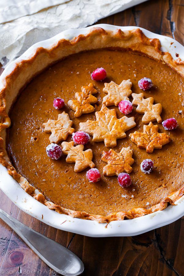 a pie topped with cookies and cranberries on top of a wooden table