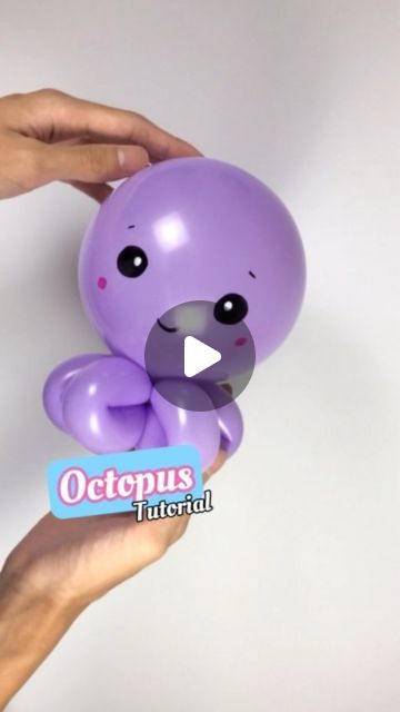 a person holding a purple teddy bear in their hand with the caption octopus material