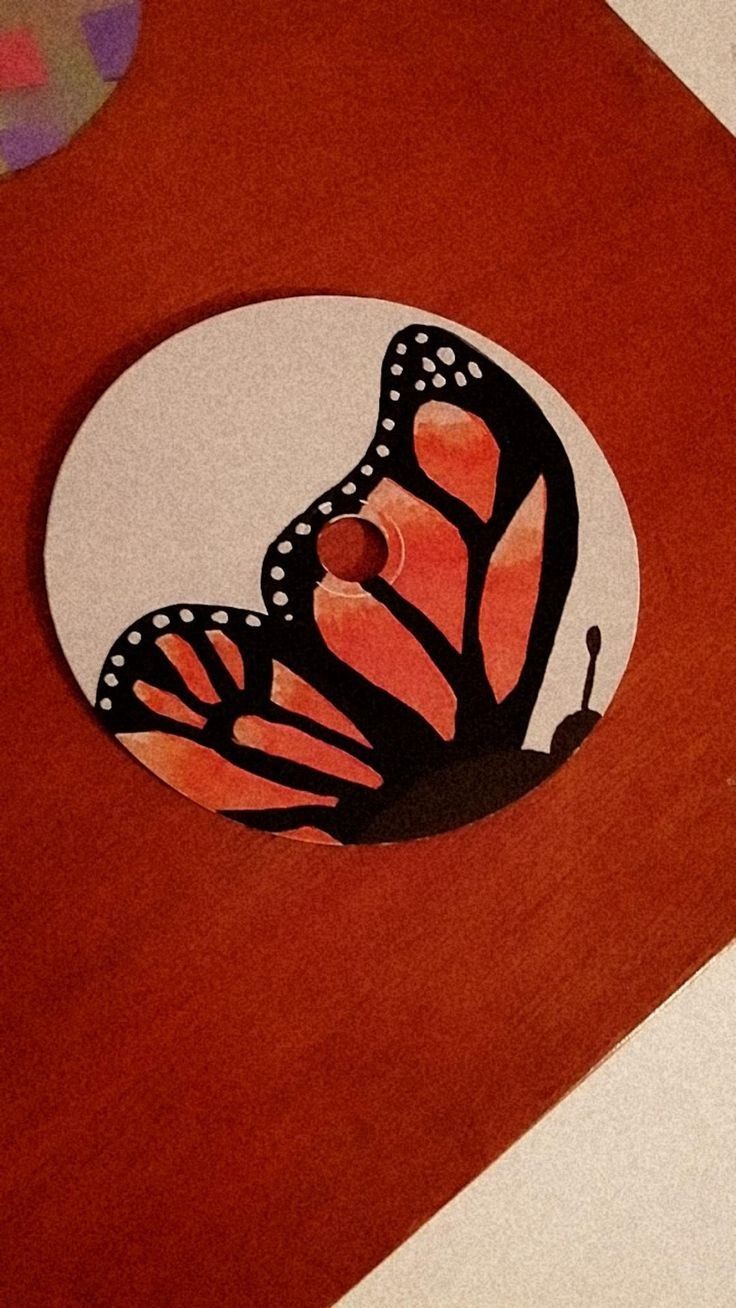 a close up of a butterfly on a piece of paper with circles around it and the image of a butterfly