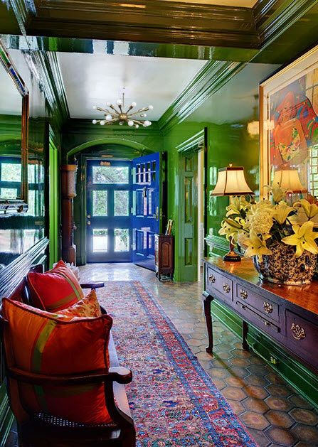 a living room with green walls and furniture