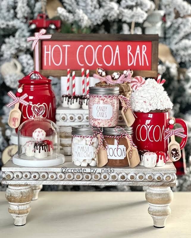 hot cocoa bar displayed in front of a christmas tree