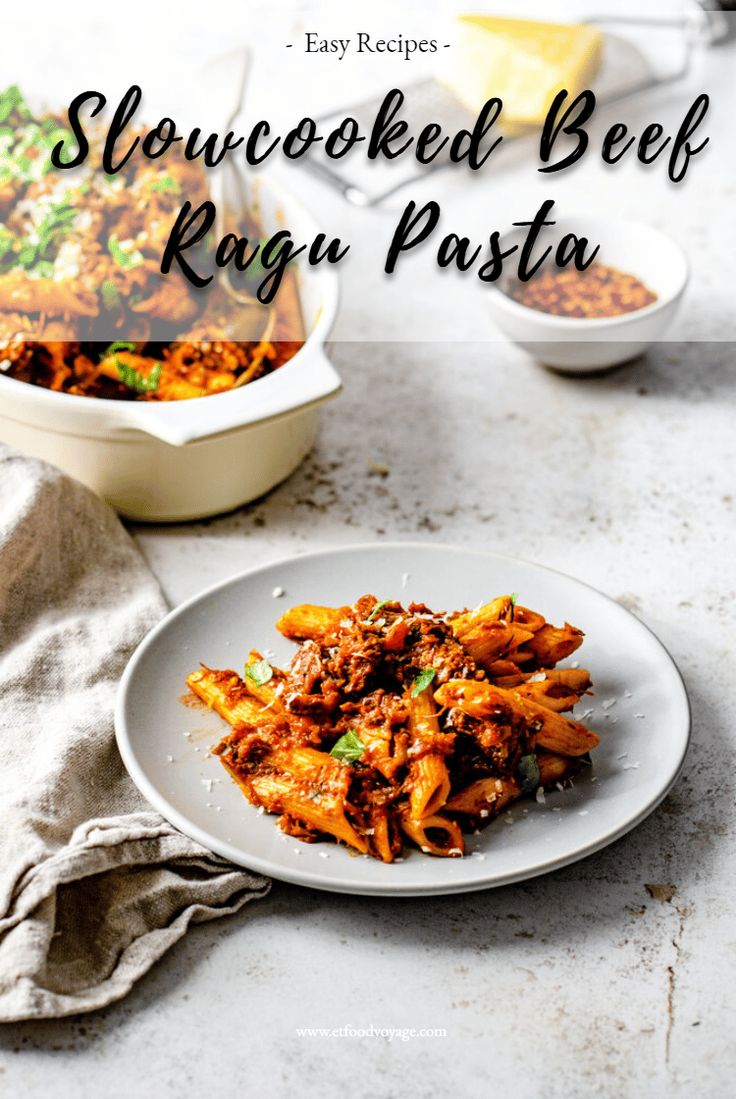 a white plate topped with pasta next to a casserole dish filled with meat