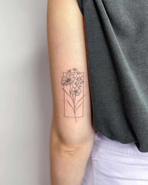 a woman's arm with a flower tattoo on the left side of her arm