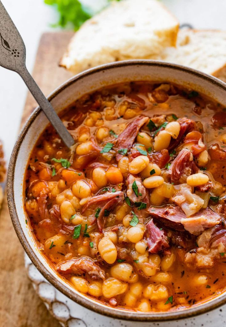 a bowl of soup with meat and beans