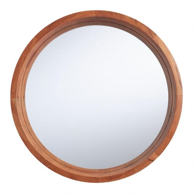 a round wooden mirror on a white background