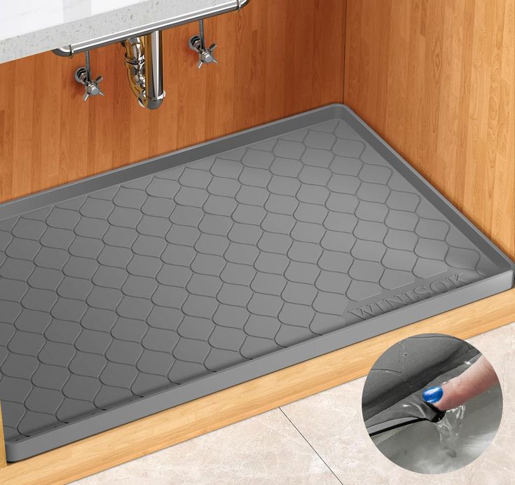 a bathroom floor mat with a person cleaning it