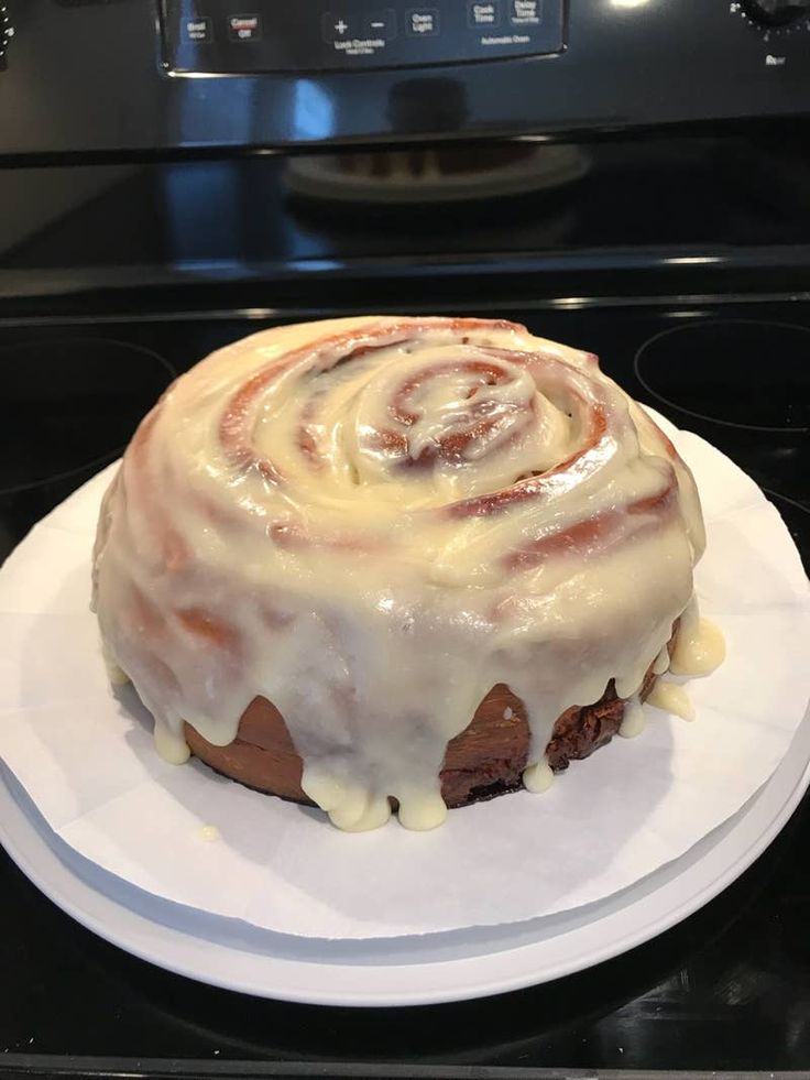 a bundt cake sitting on top of a white plate in front of an oven