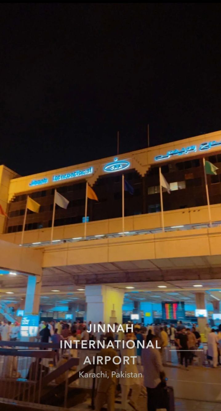 an airport terminal at night with people walking around