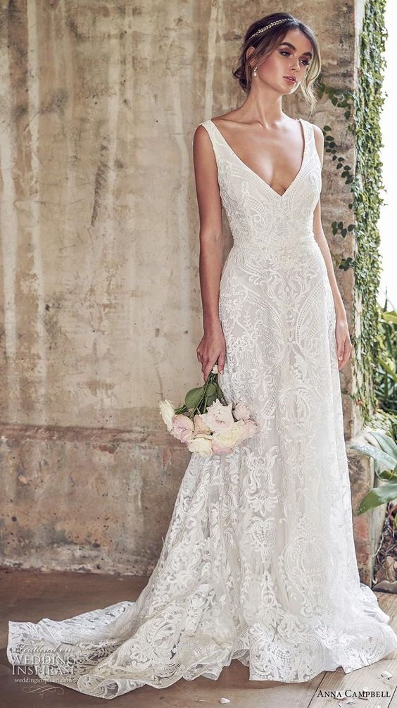 a woman in a wedding dress holding flowers