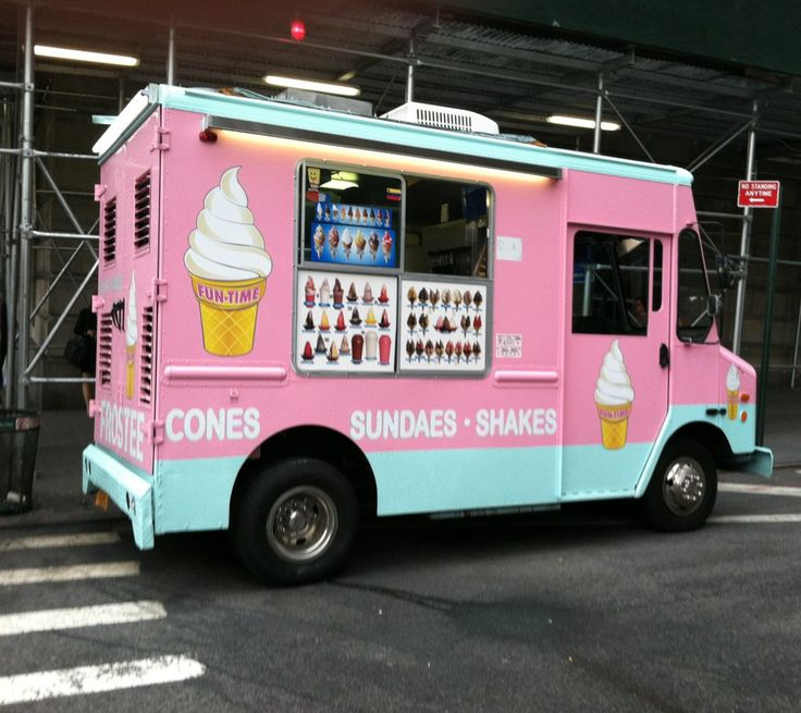 a pink and blue ice cream truck parked in a parking lot