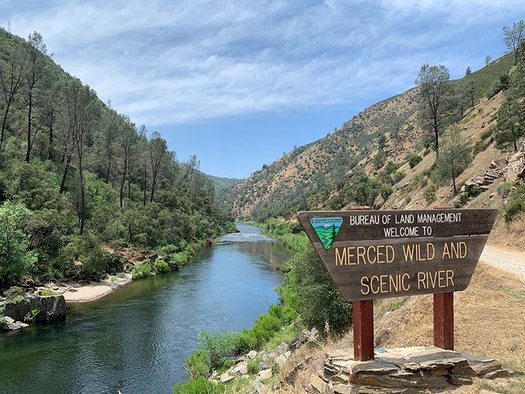 there is a sign that says merced wild and scenic river next to the road