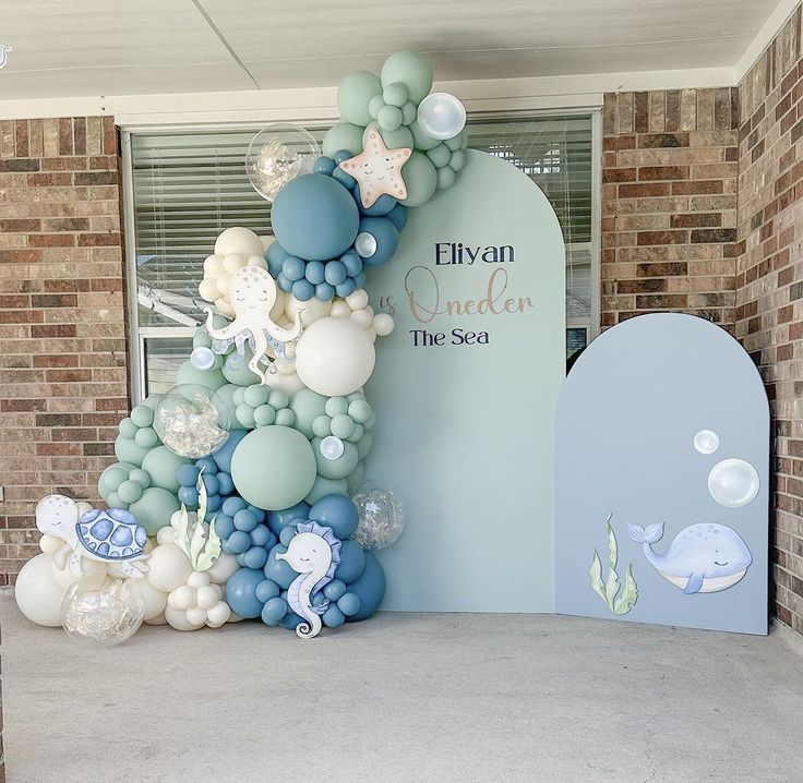 there is a very large balloon tree in front of the entrance to an ocean themed building