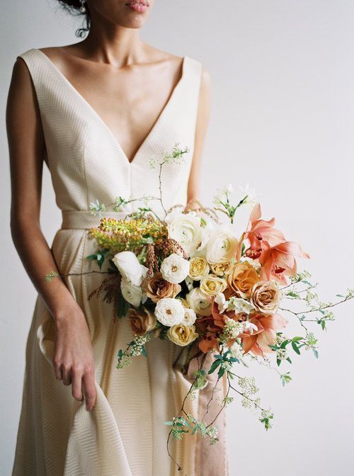 a woman in a dress holding a bouquet of flowers on her left hand and an instagram button to the right