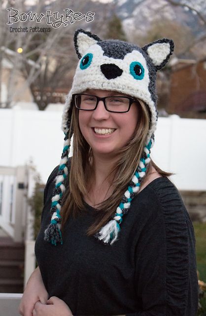 a woman wearing a knitted hat with a racoon on it