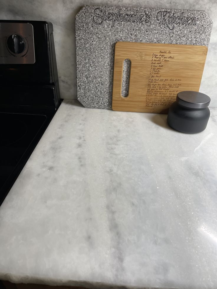 a kitchen counter with a cutting board on it and an oven in the back ground