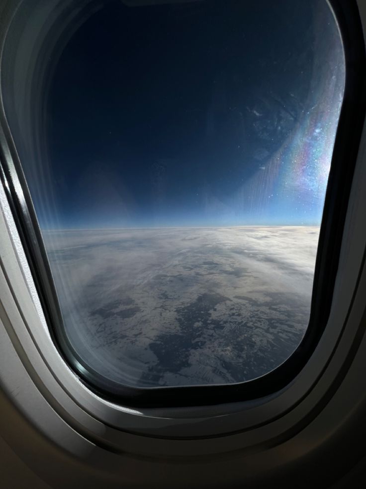 an airplane window looking out at the earth