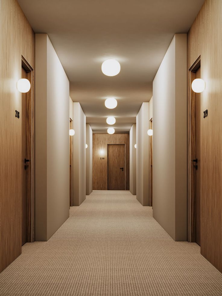 an empty hallway with three lights on either side