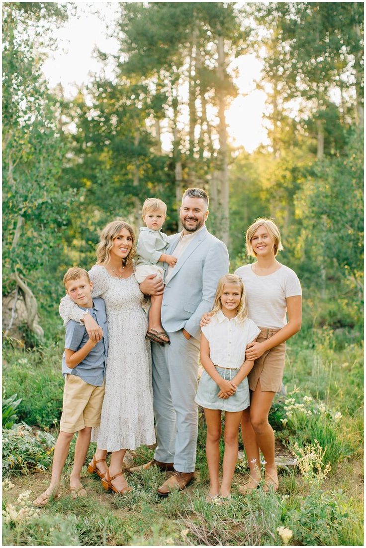 a family posing for a photo in the woods