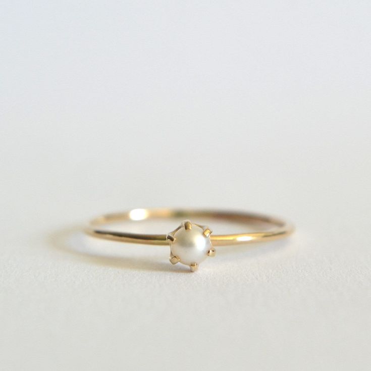 Stunning cultured freshwater pearl ring. Dainty 3mm pearl, this pearl is a beautiful cream white set in a prong setting. Polished for a beautiful shine finish.  *MATERIAL OPTIONS- -14k Solid (Yellow) Gold -14k Solid White Gold *Our 14k solid gold rings are gift wrapped in a beautiful ring box with satin bow. Made to order in your size. Sizes in drop down box are U.S. ring size.  I really want you to be happy with your purchase. If you have any questions or concerns please just let me know:) Yellow Gold Akoya Pearl Ring For Gift, Timeless Pearl White Pearl Ring, Minimalist Round Pearl Ring With Pearl Drop, Fine Jewelry Pearl Drop Ring, Timeless Round Pearl Ring As Gift, Timeless Round Pearl Ring For Gift, Fine Jewelry White Gold Pearl Ring, Timeless Pearl Ring As Gift, Delicate Yellow Gold Pearl Drop Ring