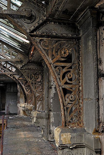 an old building with metal work on the walls