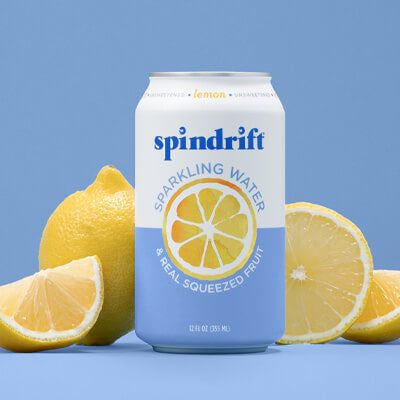 a can of spindrif sparkling water surrounded by lemons on a blue background