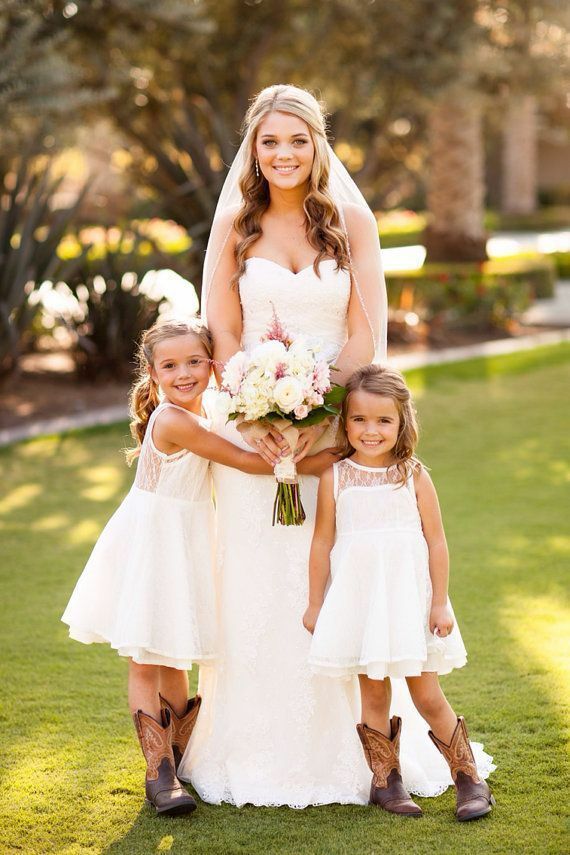 the bride and her two daughters pose for a photo