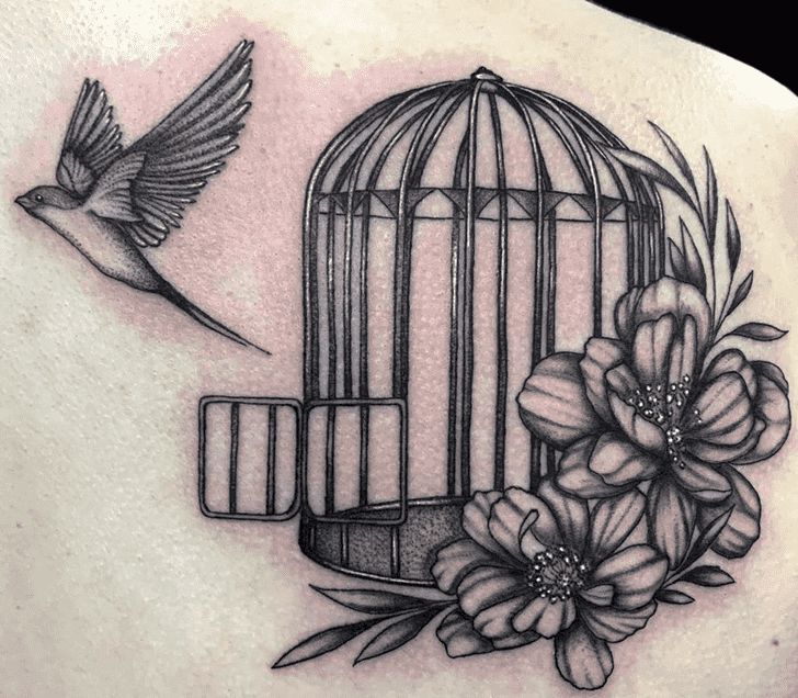 a bird in a cage with flowers and a bird on it's back tattoo