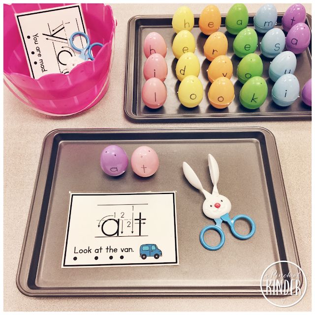 two trays filled with plastic eggs and scissors next to an easter themed counting game