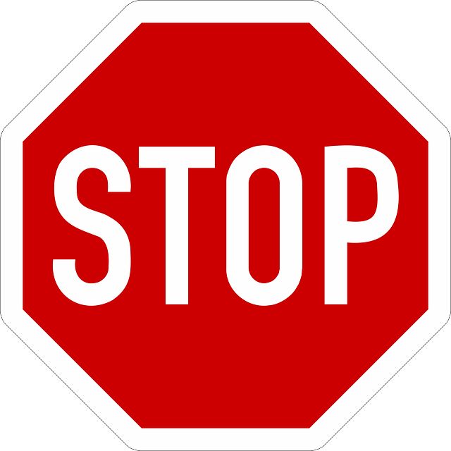 a red stop sign sitting on top of a white background with the word stop written below it