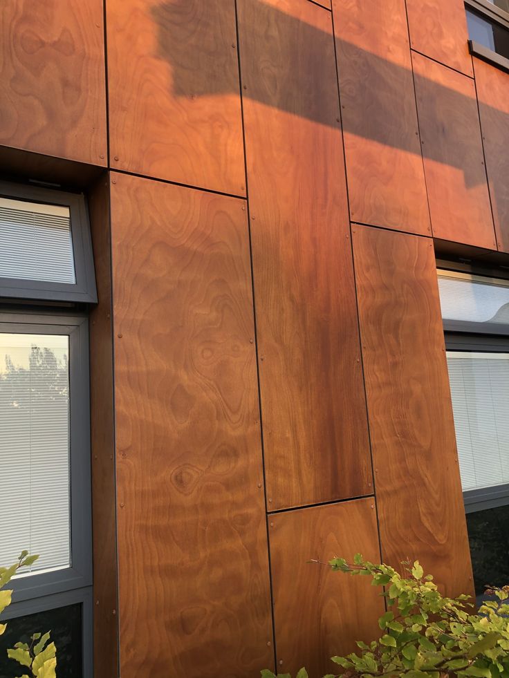 the side of a building with wood panels on it