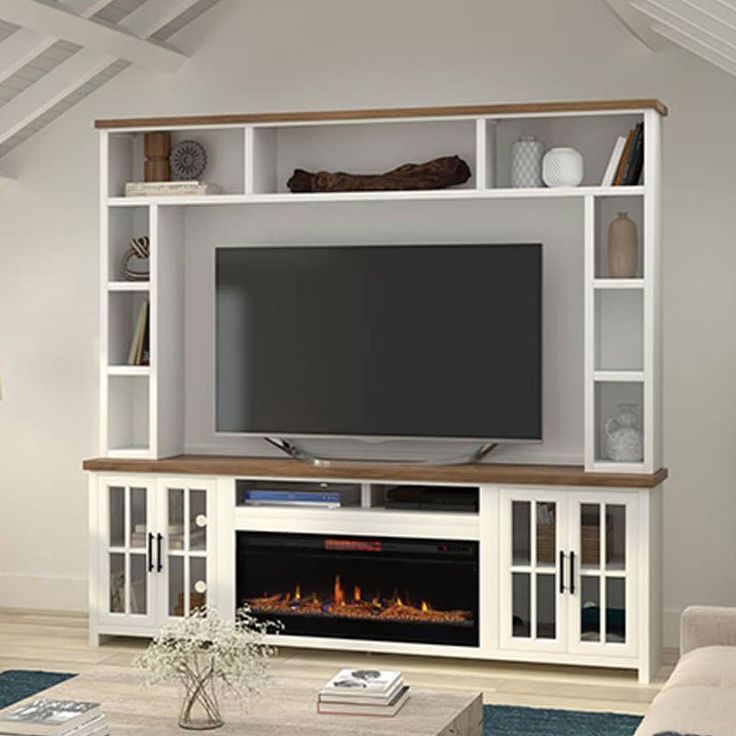 a living room with a fireplace and entertainment center