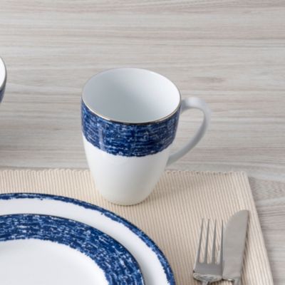 a place setting with blue and white dishes