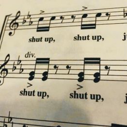 sheet music with words and notes written in black on white paper, including shut up, shut up, shut up